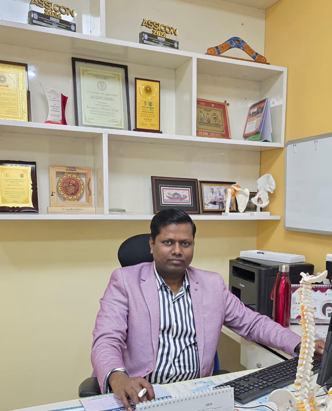 Dr. Behera consulting with patient